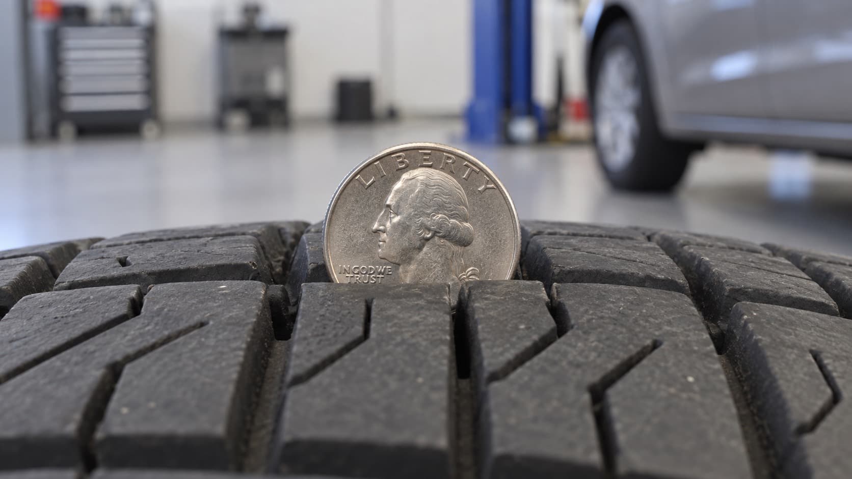 Quarter test with Washington’s head covered, showing at least 4/32 inch of tread