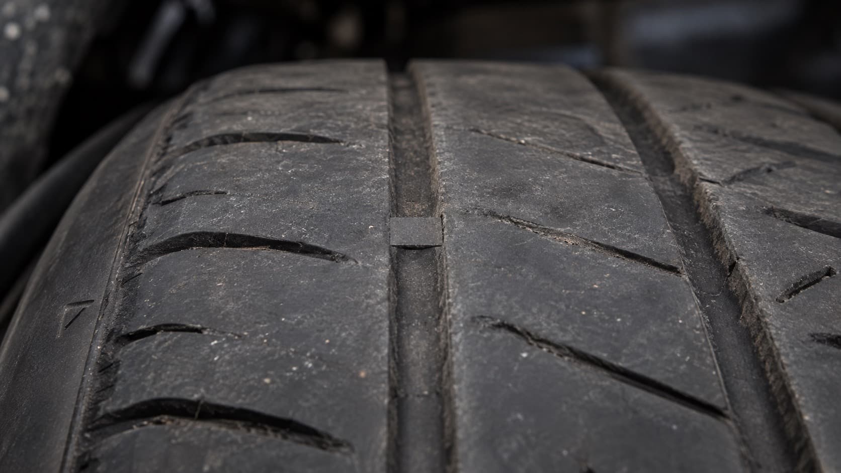 Tread wear indicator bar flush with worn tire tread