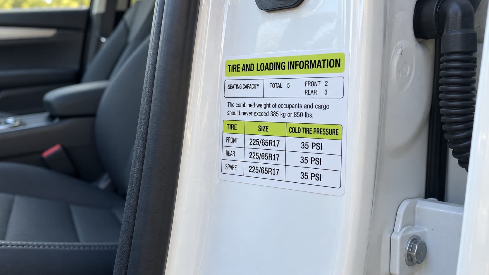 Door jamb sticker showing original tire size and recommended pressure